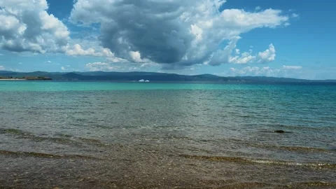 Clear turquoise water meets sandy shore. Trani Ammouda, Greece Stock Footage 340638149