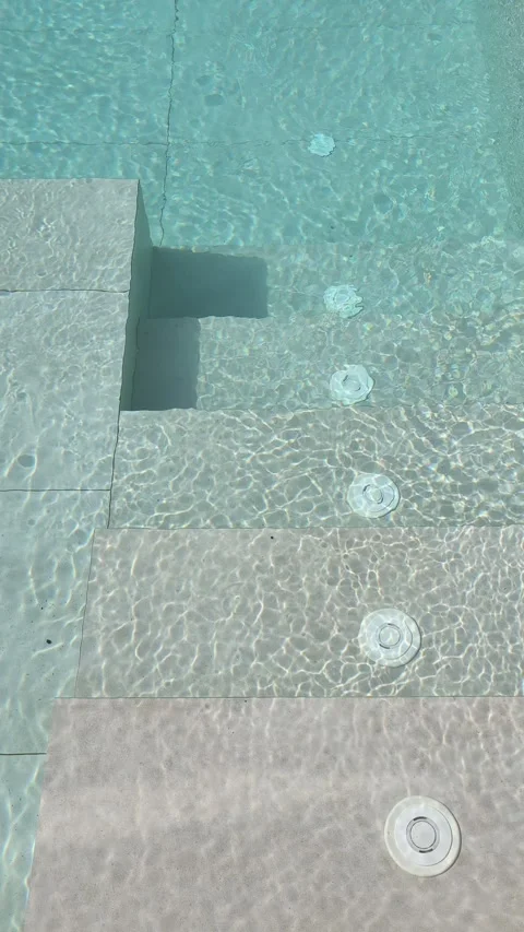 Clear turquoise water rippling over swimming pool steps Stock-Footage 340418456
