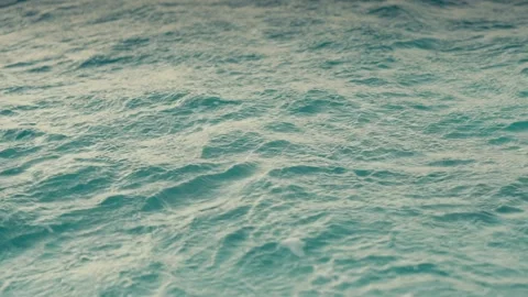Clear Turquoise Water Surface with Ripples and Ocean Currents in Slow Motion Stock Footage 345396762