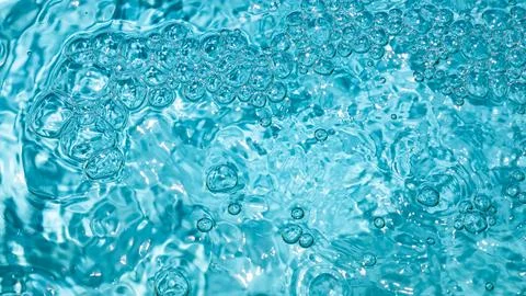 Clear turquoise water texture. Patterns of bubbles. Light dances on waters Stock Photos