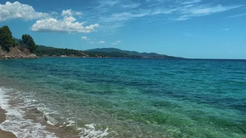 Clear turquoise waves lap golden sand gently. Lagomandra, Greece Stock-Footage 339025836