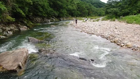 Clear valley water flowing under the caving mountains_4 Stock Footage 280179235