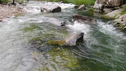 Clear valley water flowing under the caving mountains_2 Stock Footage 280179300