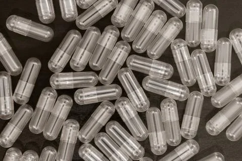 Clear Vegetable Capsules on Dark Background Stock-Fotos
