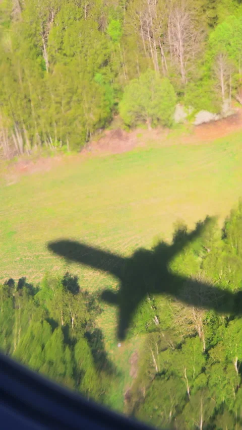 A clear view from above, capturing the shadow of an airplane flying over a .. Stock Footage 287123926