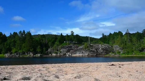 Clear view of a riverbank in Norway during daytime with trees and rocks nea.. Stock Footage 340213948