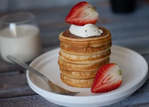 Clear view of Stack of pancakes with honey stick, strawberry, blue berry and  Stock Photos
