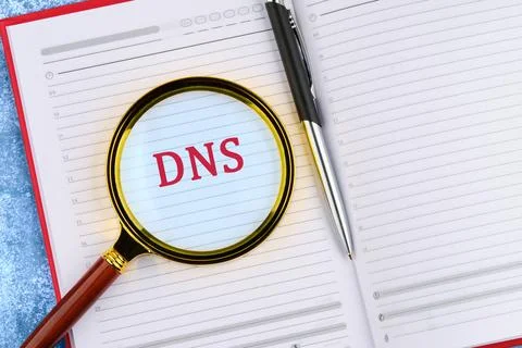 A clear view of the term DNS, highlighted through a magnifying glass on a not Stock Photos