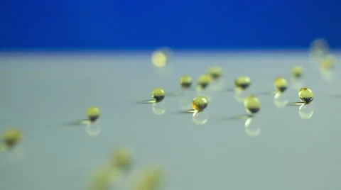 Clear Vitamin/Drug Capsules Dropping in Slow Motion. Stock Footage 58414178