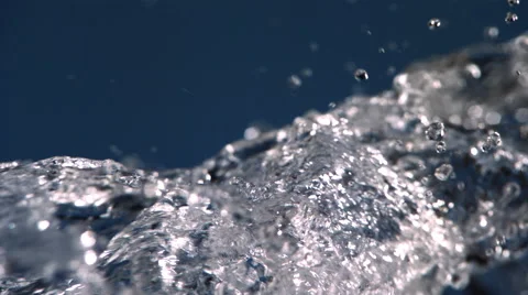 Clear water bubbling up in ultra-slow motion on blue frame Stock Footage 59527219