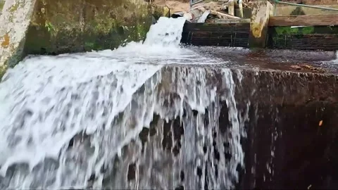 Clear water cascading over a man-made structure Stock Footage 341679642