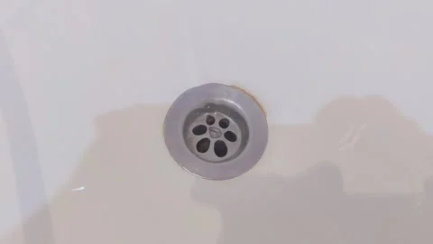 Clear Water Draining Through Metal Drain Hole in White Bathtub Stock Footage 341343461