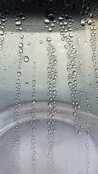 Clear water drop pattern on transparent glass texture closeup Stock Photos