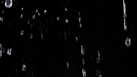 Clear Water Droplets Fall Against an Isolated Black Background, Macro View Highl Stock Footage 341413704