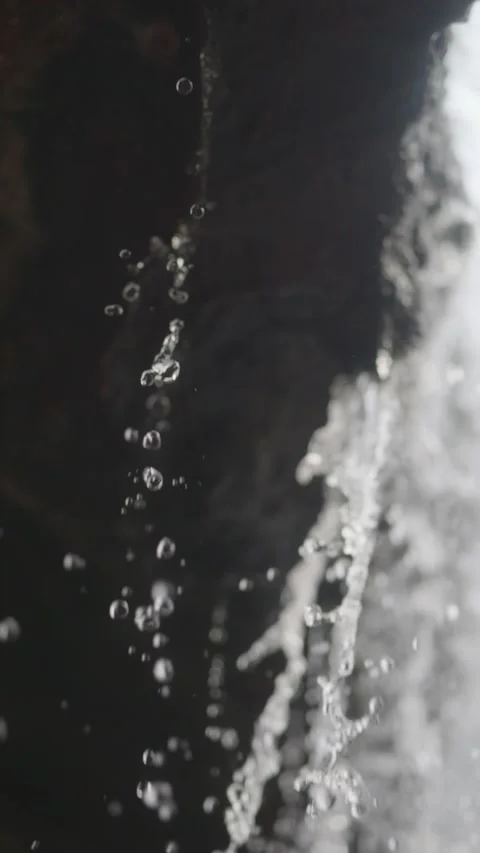 Clear water droplets fall from rocks in slow motion, each drop highlighted... Stock-Footage 291869094
