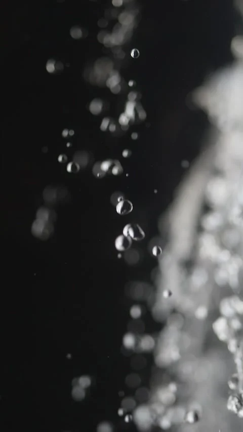 Clear water falls from rocks in slow motion, each droplet vivid. A waterfal.. Video stock 291094138