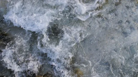 Clear water flowing down a manmade stream, river or canal in a mountain village. Stock Footage 156941957