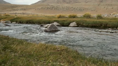 Clear water flowing in a small fast mountain river, slow movement Stock Footage 130373361