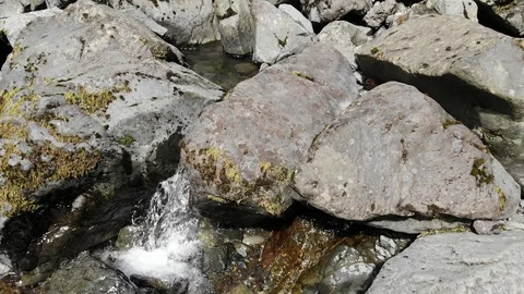 Clear water flowing through rocks Stock Footage 107343682