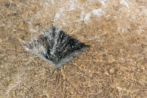 Clear water flows down into an outflow Foto stock