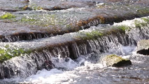 Clear water flows down with a splash. Stock Footage 130240129