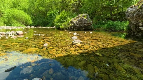 Clear water flows gently over smooth stones. Gostilje Waterfall, Serbia. Stock Footage 337060956