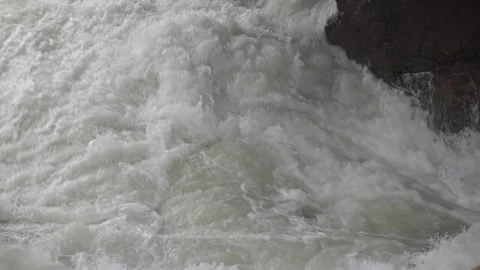 Clear water flows gently through a natural setting, creating a calm and soothing Stock Footage 329141101