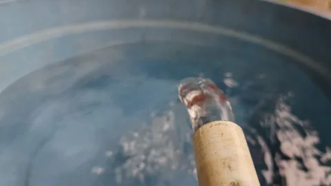 Clear water flows gracefully from the PVC pipe into the basin Stock Footage 304055887