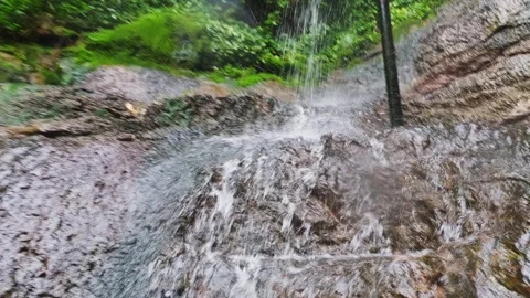Clear water flows from the mountains to form waterfalls Stock Footage 302946077