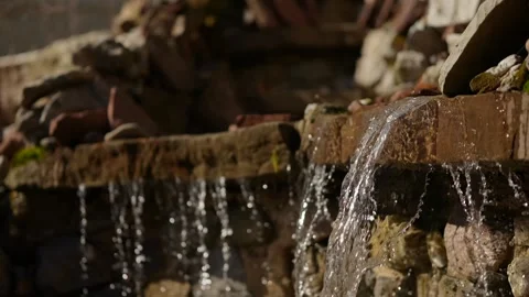 Clear water flows over a rustic stone ledge Stock Footage 346298857