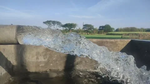 Clear water flows profusely from the irrigation pipes of the fields, Stock Footage 249393419