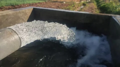 Clear water flows profusely from the irrigation pipes of the fields, Stock Footage 249393424