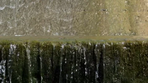Clear water flows slowly down the dam wall Video stock 321798714