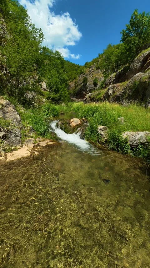 Clear water flows through rocky, green valley. Gradasnica River Canyon, Vertical 库存影片 342327206