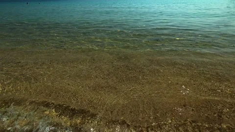 Clear water gently laps golden sand. Trani Ammouda, Greece Stock Footage 338347488