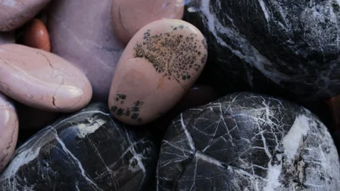 Clear water gently trickling down onto a group of wet smooth stones, creati.. Stock Footage 320734663