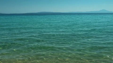 Clear water laps gently at the shore. Trani Ammouda, Greece Stock Footage 339613195