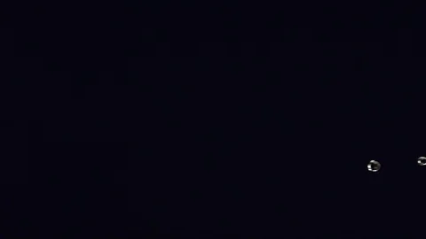 Clear water liquid falling and pouring across black backdrop A Stock Footage 109572385