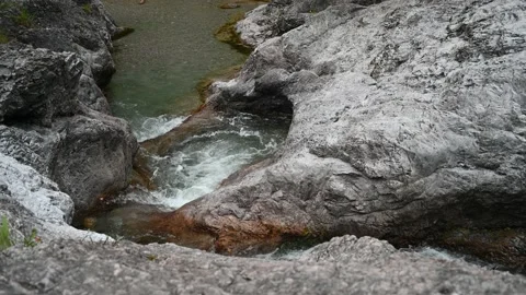 Clear water of a mountain river is flowing between rocks Stock Footage 211453468
