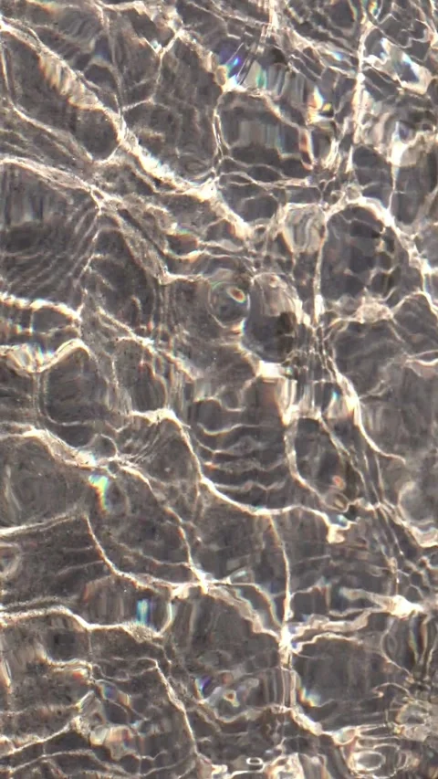 Clear water over sand with caustics, vertical loopable abstract background Stock Footage 333272408