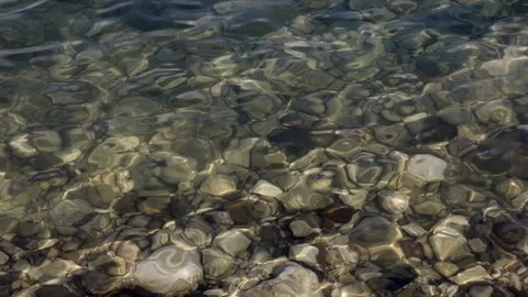Clear water over smooth pebbles at Lake Garda in Sirmione Stock Footage 301723565