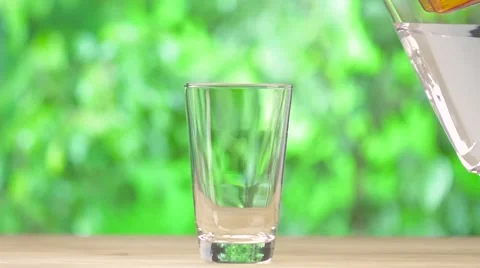 Clear water pouring from water filter on nature background Stock Footage 55912201