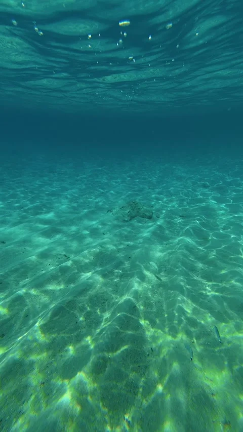 Clear water ripples beneath surface. Kalogria, Greece. Vertical Stock-Footage 338358638