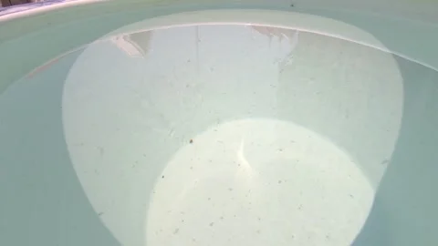 Clear Water Ripples in Ceramic Container with Sunlight Reflection Видео 332942761