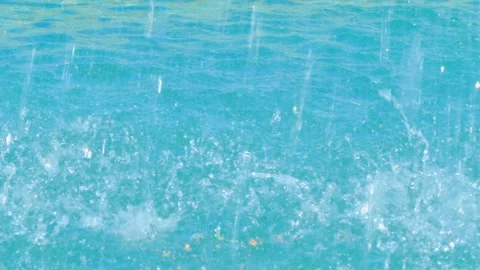 Clear water splashes in a vibrant blue fountain, capturing motion and vibrancy Stock Footage 324476555