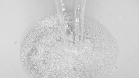 Clear water stream creating bubbles in sink Stock Footage 317125495