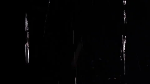 Clear Water Streams Fall Against a Black Background, Creating a Dramatic Abstrac Stock Footage 341421593