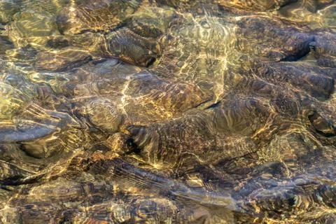 Clear water surface with movement over glowing Stock Photos