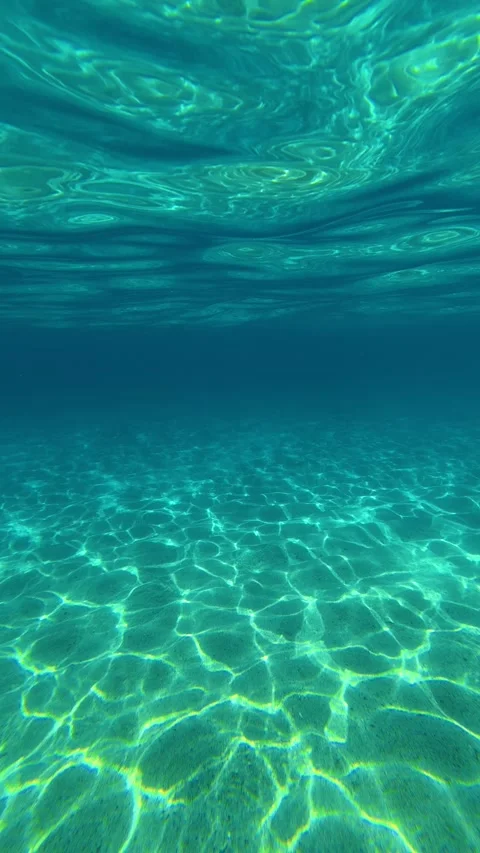 Clear water sways gently above sandy ocean floor. Lagomandra, Greece. Vertical Stock Footage 339627392