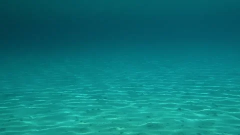 Clear water sways gently over sandy ocean floor. Trani Ammouda, Greece Stock Footage 339609376